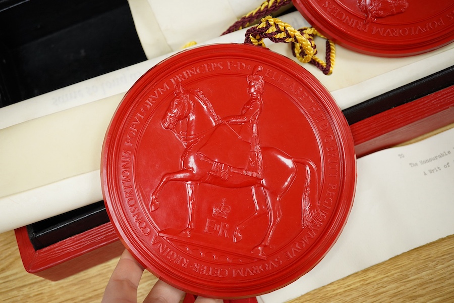 The Hon. Lord Justice Slade, ‘A Writ of Attendance at Parliament’, two vellum documents with ERII red seals in a red fitted case with a gold Royal Coat of Arms stamp, case 59cm wide x 23cm deep. Condition - some foxing